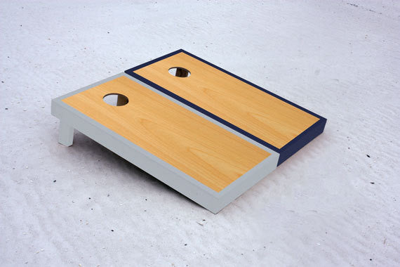 Custom cornhole boards with Navy and Gray borders with natural stained center